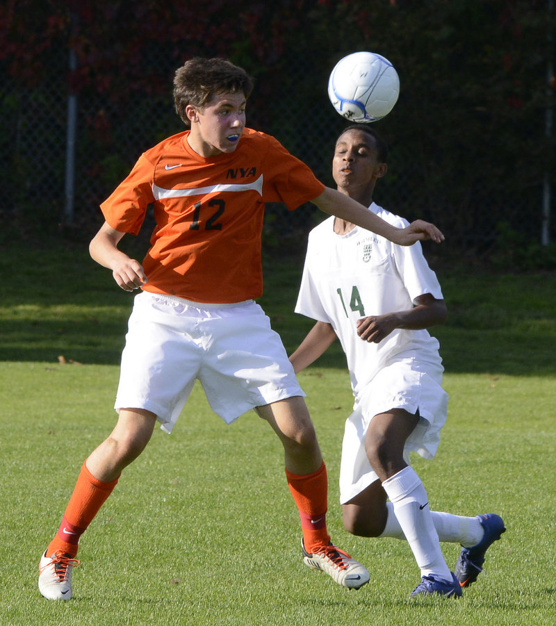 Greyson Cohen of North Yarmouth Academy attempts to keep the ball away from Abel Alemayo of Waynflete during NYA’s 1-0 victory in Portland.