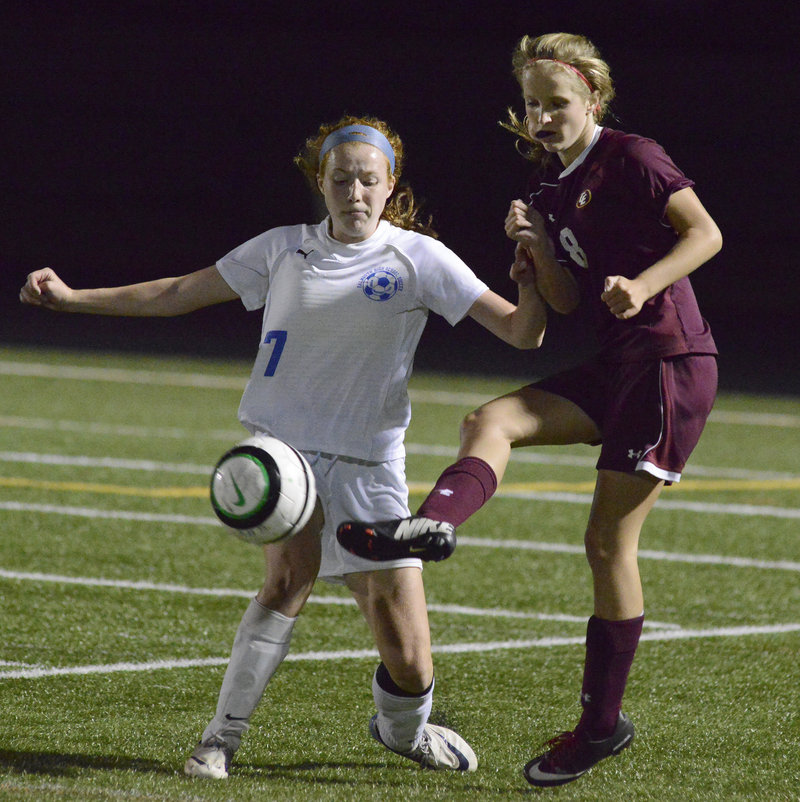 Kate Breed of Cape Elizabeth, right, kicks the ball past Emma England of Falmouth during their Western Maine Conference game at Falmouth High.