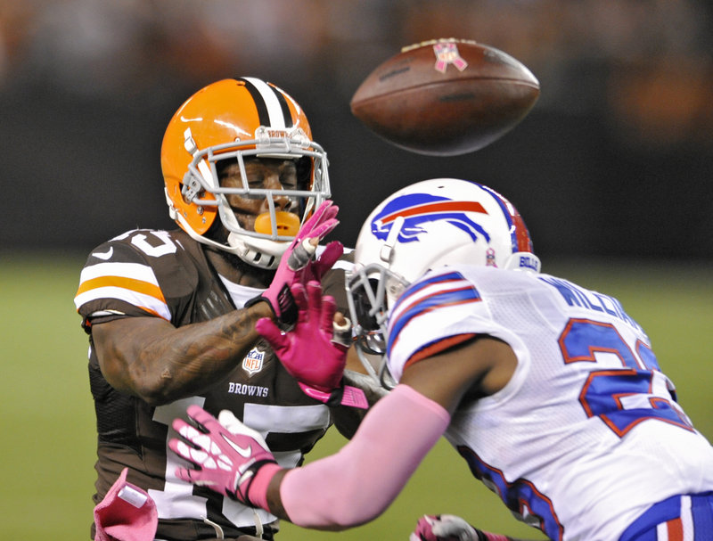 Buffalo safety Aaron Williams, right, breaks up a pass intended for Cleveland wide receiver Davone Bess during first-quarter action of Thursday night’s NFL game in Cleveland, won by the Browns.