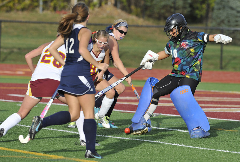 Westbrook goalie Nicole Miranda blocks a shot, only to have Thornton Academy's Libby Pomerleau, center, knock the ball into the net for the first goal of the game Friday. The Trojans scored twice in the second half for a 2-0 win.