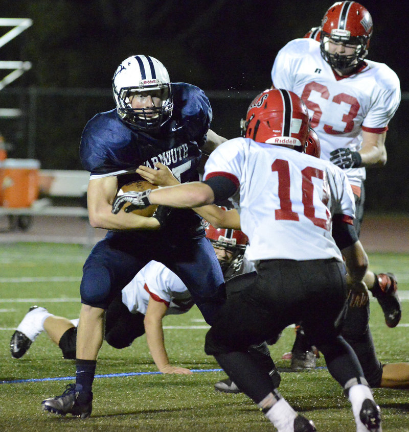 Yarmouth running back Matt Woodbury looks for room to run as Jake Moody and other Wells defenders move in for the tackle.