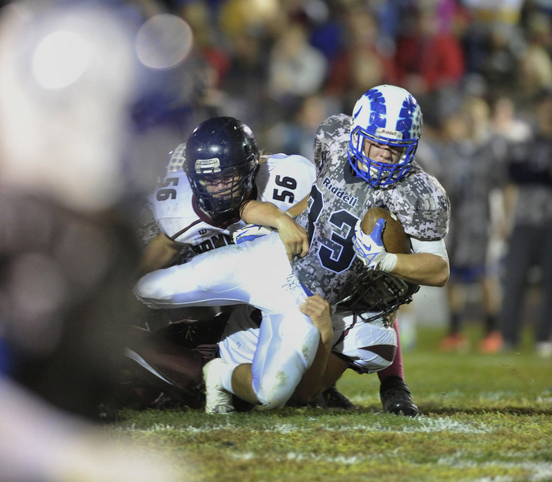 Nicco DeLorenzo of Kennebunk is pulled down after a big gain Friday night during the 42-14 victory against Greely. The Rams imporved to 5-0 in Western Class B and dropped the Rangers to 3-2.