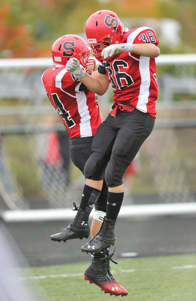 Brendan Smith, left, and Dan LeClair of Scarborough celebrate Smith’s touchdown reception in the first half.