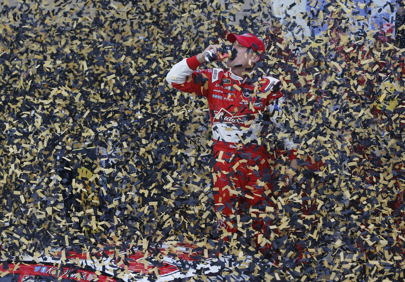 Kevin Harvick celebrated in black and gold Sunday after he pulled away from Kurt Busch and Jeff Gordon to win a wreck-filled race at Kansas Speedway, leaving him in third place in the Sprint standings and in position to advance on Matt Kenseth and Jimmie Johnson.