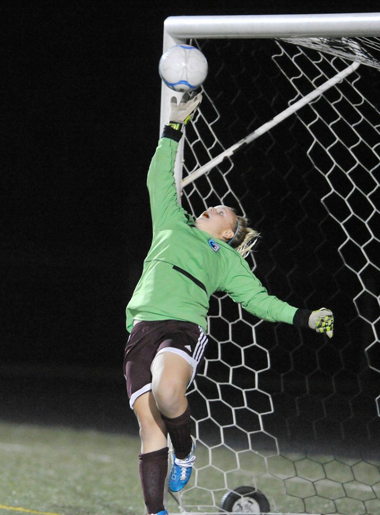 Gorham goalie Renae Staples leaps high, but can’t reach the winning goal by Scarborough’s Ashley Perriello Monday.