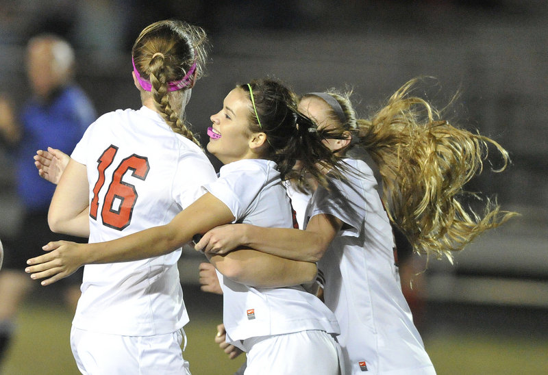 Ashley Perriello, middle, of Scarborough celebrates with Sam Sparda, left, and Morgan Rodway after scoring the only goal in Monday night’s win over Gorham.