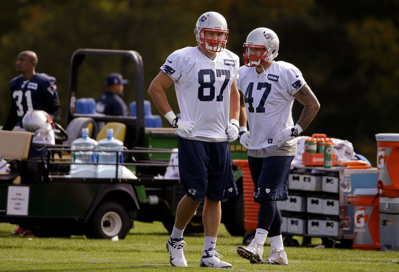 Rob Gronkowski, left, with fellow tight end Michael Hoomanawanui, may be able to play Sunday for the first time this season, but the team isn’t making his status known.