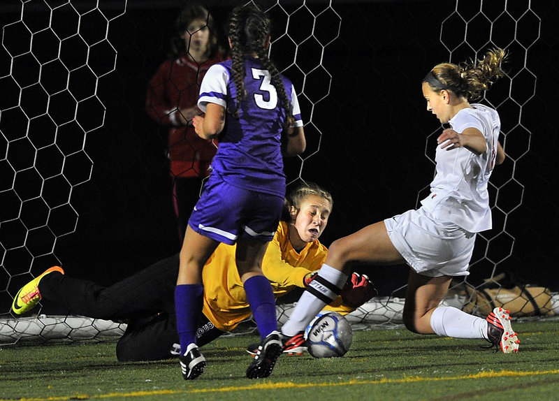 Deering goalkeeper Lee Ann Downs comes out to smother a shot by Hadlee Yescott of Scarborough during undefeated Scarborough’s 2-1 victory Wednesday night.