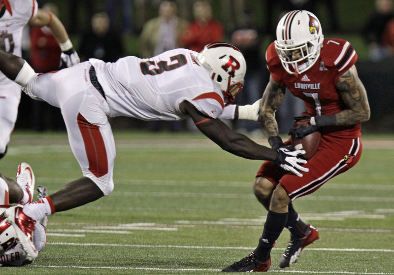 Louisville receiver Damian Copeland eventually got the handle on this pass as Rutgers’ Steve Longa pressures the play during No. 8 Louisville’s 24-10 win at home Thursday night.