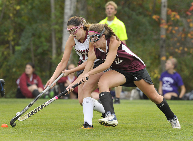 Dani Foster, left, of Freeport battles for possession of the ball with Brennah Marin of Greely. Greely forced overtime with a penalty goal after regulation time expired and won in overtime, 2-1.