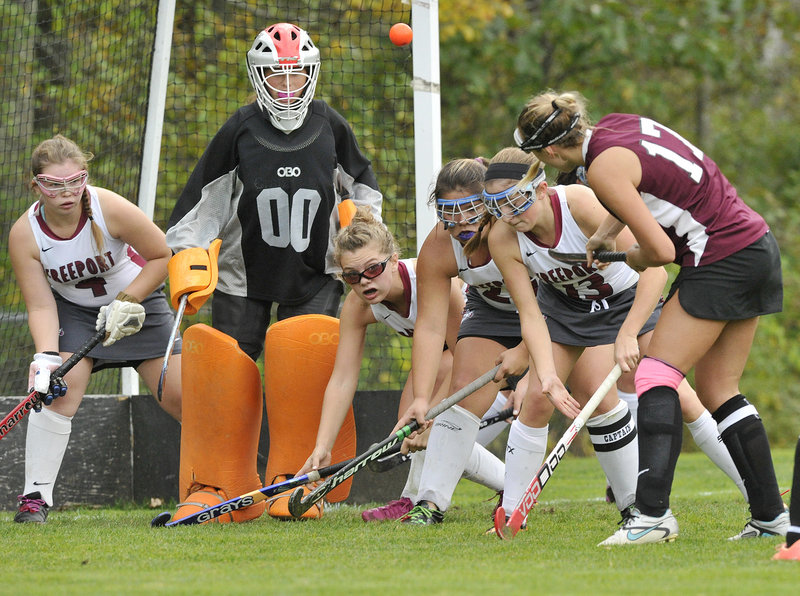 Cassie Demick of Greely lifts a high shot toward Freeport goalie Morgan Karnes during their Western Maine Conference field hockey game Friday in Freeport.