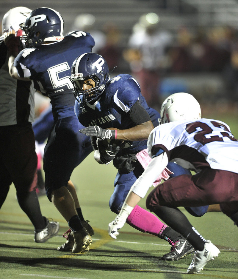 Jayvon Pitts-Young of Portland finds a hole to gain yardage Friday night during the Bulldogs' 57-14 victory against Windham at Fitzpatrick Stadium.