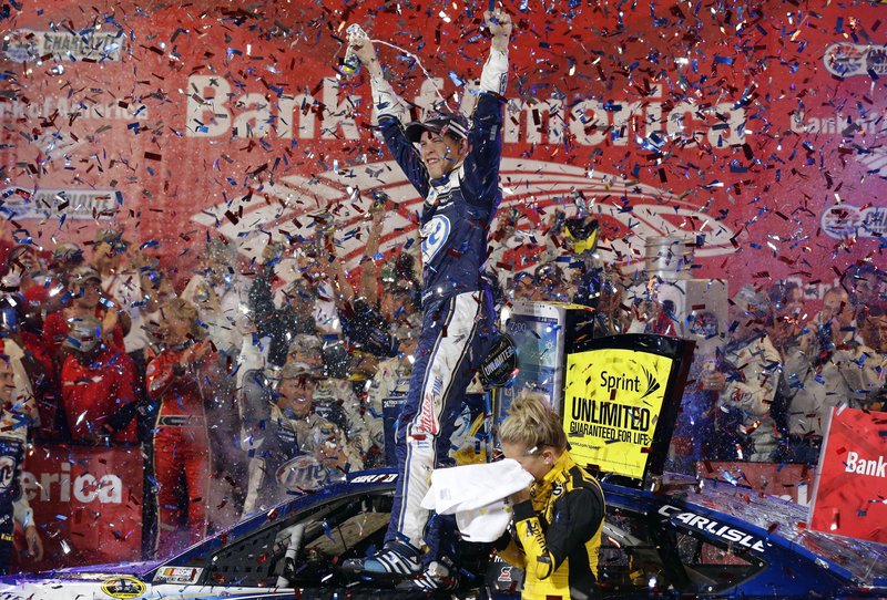 Brad Keselowski celebrates amid a cloud of confetti after winning the NASCAR Sprint Cup Series race at Charlotte Motor Speedway in Concord, N.C., on Saturday night.