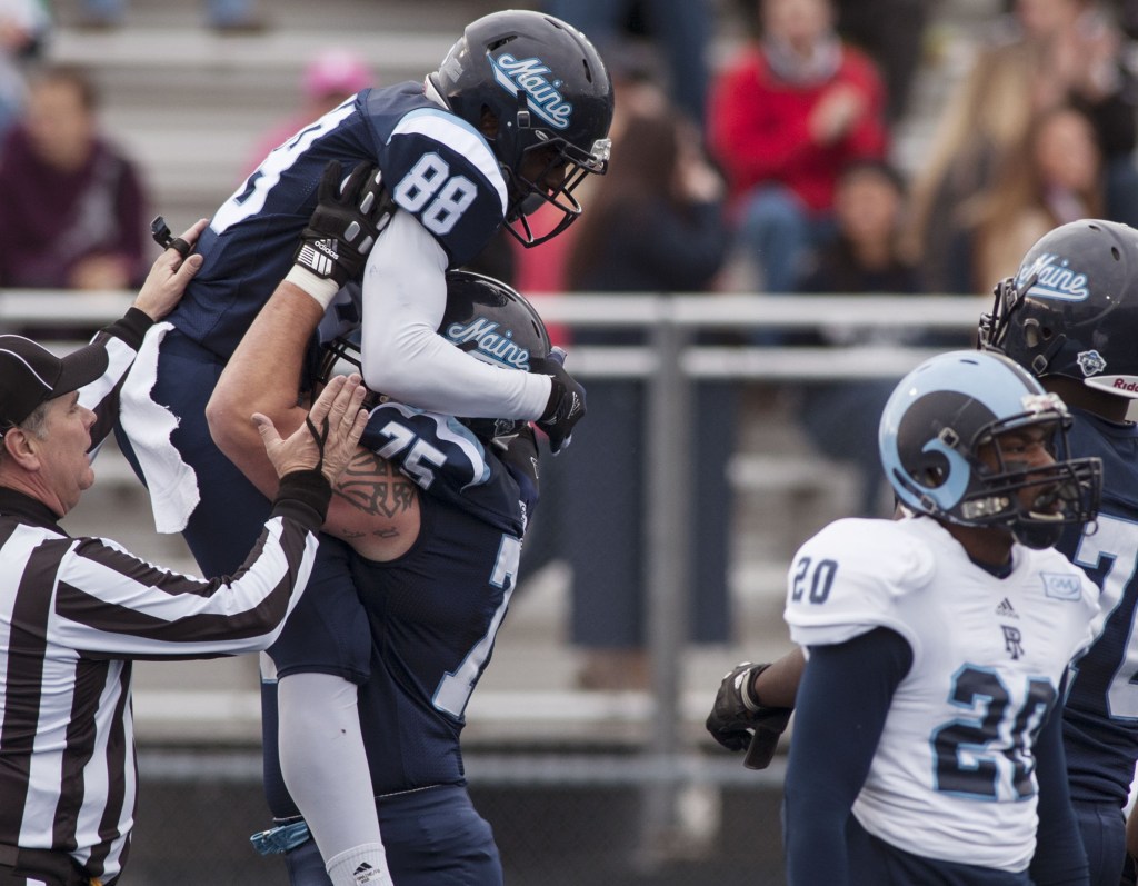 Maine wide receiver DamarrAultmann, 88, celebrates with teammate Joseph Hook after scoring against Rhode Island in the first half of Maine’s 41-0 victory Saturday at Orono. The Black Bears