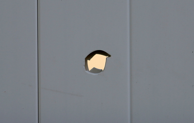 The bullethole in Toni Macquinn’s backyard fence in Old Orchard Beach where a stray bullet from a hunter’s rifle pierced the fence Wednesday, Nov. 20, 2013.