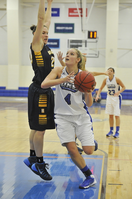 UNE's Brooke Flaherty rolls around USM's Rebecca Knight for a layup.