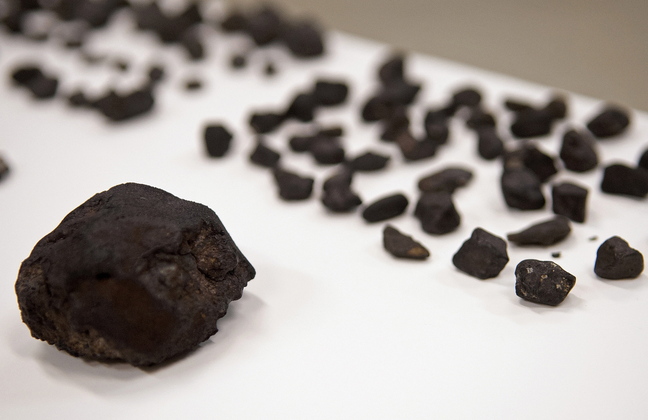 This photo provided by The Field Museum in Chicago shows pieces of the meteor that exploded over Russia’s Ural Mountains in February after they were catalogued on their arrival at the museum. The museum received nearly two pounds of small meteorite pieces donated by a collector.
