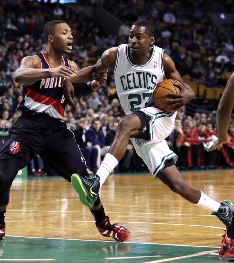 Guard Jordan Crawford drives to the basket against Portland guard Damian Lillard during Friday’s game in Boston, won by the Trail Blazers, 109-96.