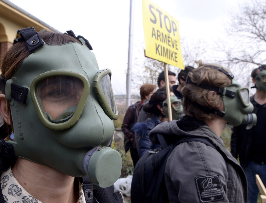 People wearing gas masks protest at the Albanian Embassy in Skopje, Macedonia, on Thursday. Separate rallies in Albania oppose plans to destroy Syrian chemical weapons in Albania.