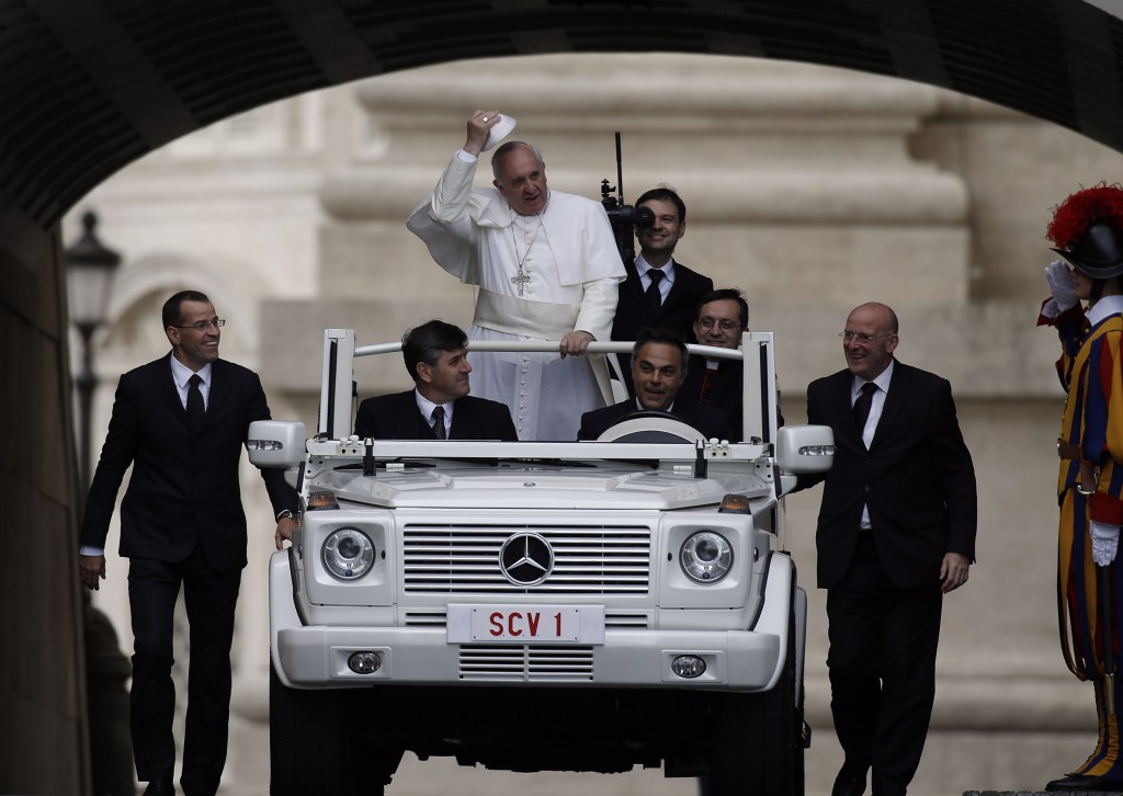Pope Francis, escorted by security guards, arrives in St. Peter’s Square for the weekly general audience at the Vatican on Wednesday.