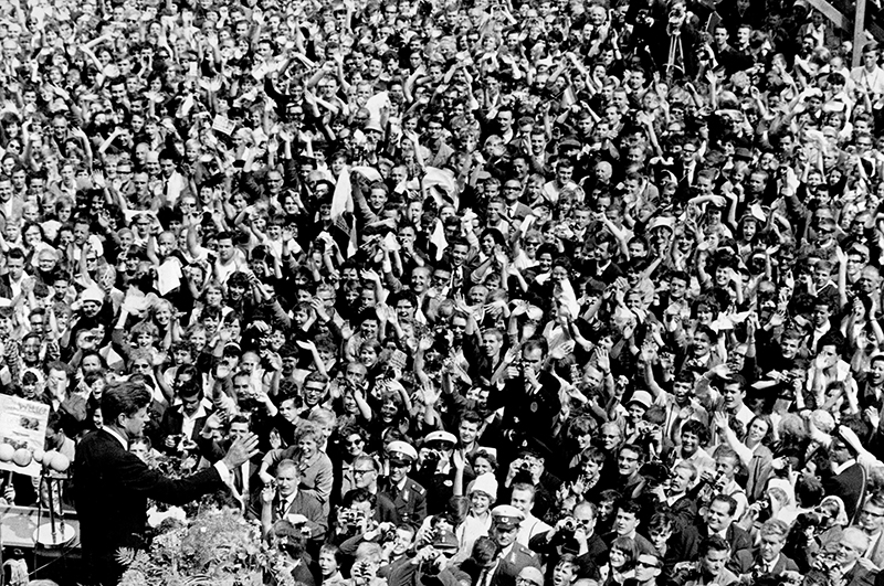 In this June 26, 1963 file photo, U.S. President John F. Kennedy, left, waves to a crowd of more than 300,000 gathered to hear his speech where he declared "Ich bin ein Berliner," ("I am a Berliner,") in the main square in front of Schoeneberg City Hall in West Berlin.