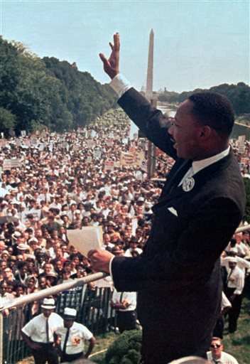 In this Aug. 28, 1963 file photo, The Rev. Martin Luther King Jr. waves to the crowd at the Lincoln Memorial for his "I Have a Dream" speech during the March on Washington. The march was organized to support proposed civil rights legislation and end segregation.