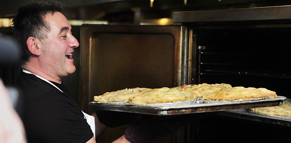 Stuart Leckie, manager of the food service program at St. Joseph’s College and coordinator of the annual bake-off, rejoices at the first batch of baked apple pies on Wednesday.