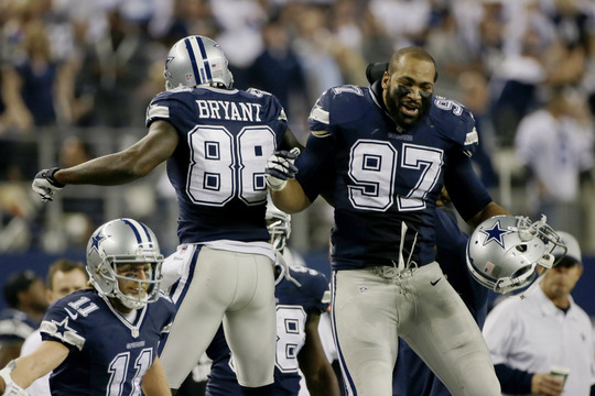 Dez Bryant of the Dallas Cowboys celebrates with Jason Hatcher after scoring a second-half touchdown Thursday en route to a 31-24 victory at home against the Oakland Raiders.
