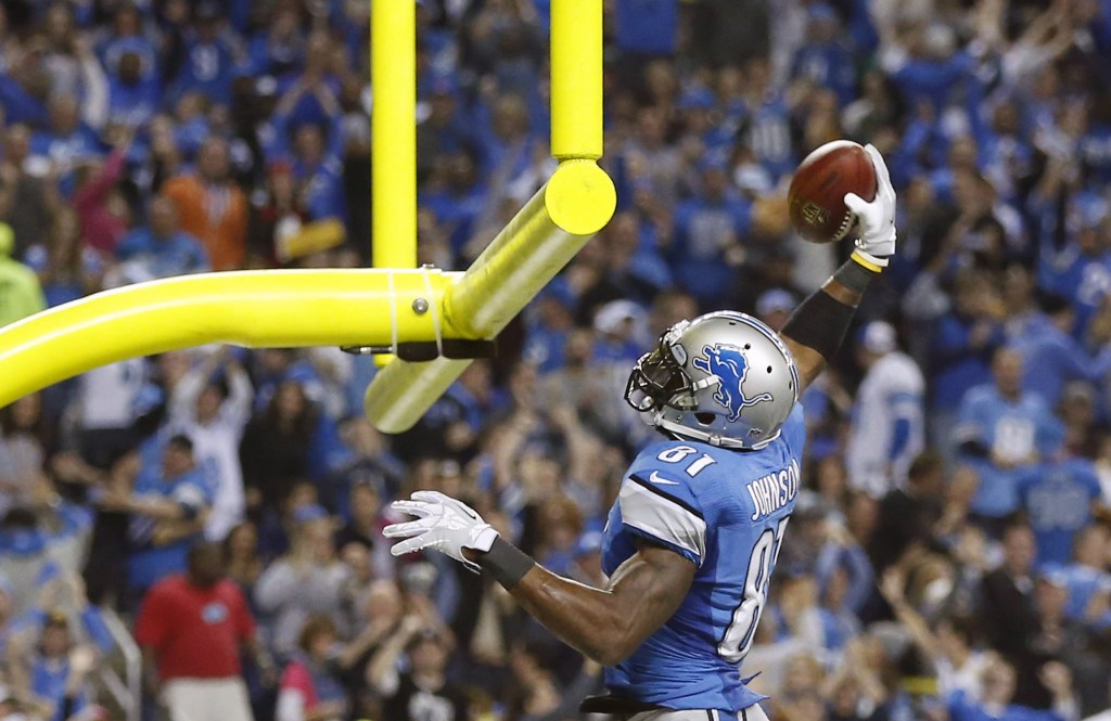 Detroit's Calvin Johnson slam-dunks the ball after catching a TD pass, much the way the Lions slam-dunked the suddenly very mediocre Packers on Thanksgiving.