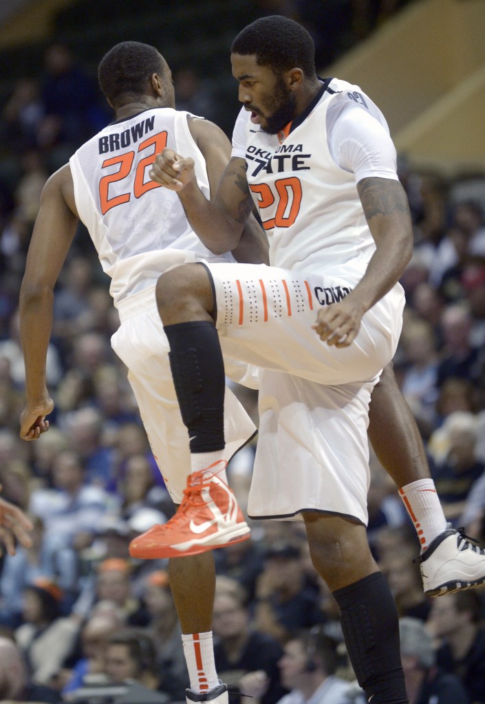 Markel Brown, left, and Michael Cobbins of Oklahoma State celebrate during a first-half timeout Thursday. Too early to celebrate? Maybe, but the Cowboys went on to beat Purdue.