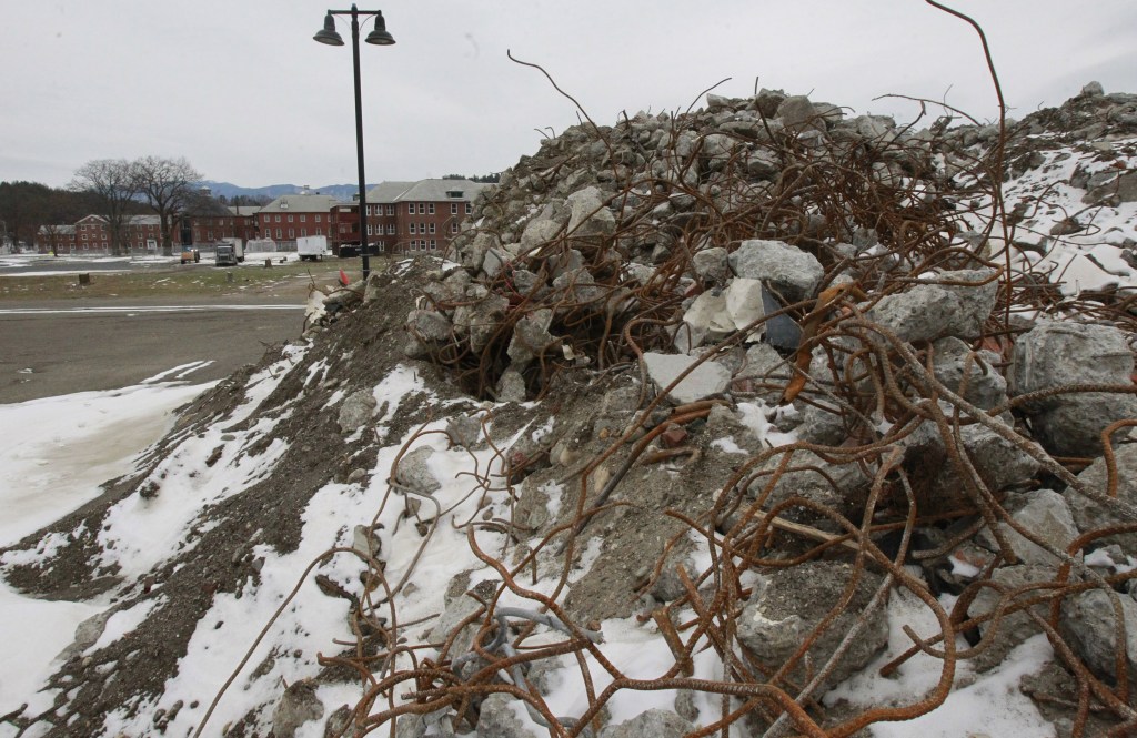 Rubble is piled where the Osgood Building stood at the state office complex in Waterbury, Vt. The complex was damaged by flooding.