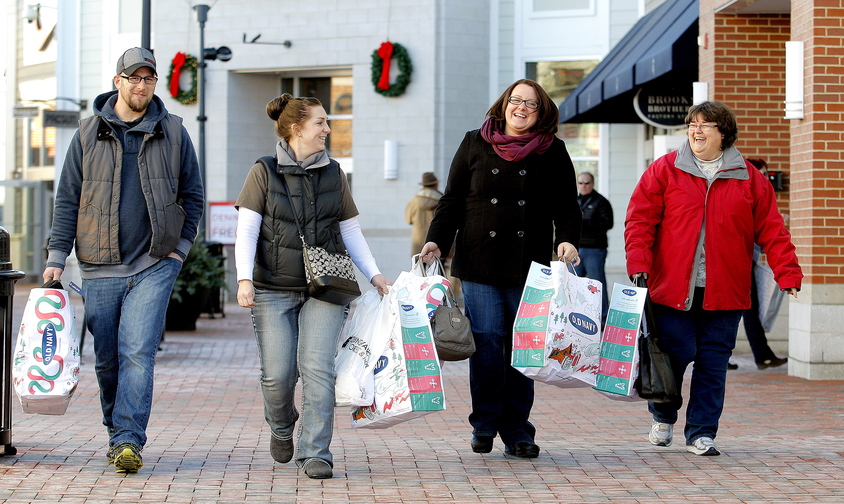 From left, Matt and Amy Powell of Durham, along with Danielle Marston of Norway and mother-in-law Brenda Marston of Oxford, make their way back to their vehicle after shopping at the outlets in Freeport on Friday.