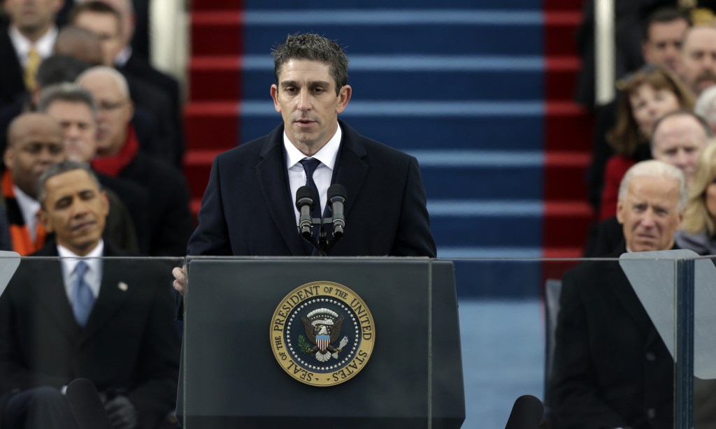 In this Jan. 21, 2013 file photo, poet Richard Blanco speaks at the U.S. Capitol in Washington during the inauguration for President Barack Obama, left, and Vice President Joe Biden right. Blanco describes writing the inaugural poem in his new book, ìFor All of Us, One Today: An Inaugural Poetís Journey.î A Cuban-American who grew up in Miami, Blanco says he was he was forced to re-examine his relationship with his adopted country in the weeks leading up to the inauguration. (AP Photo/Pablo Martinez Monsivais)
