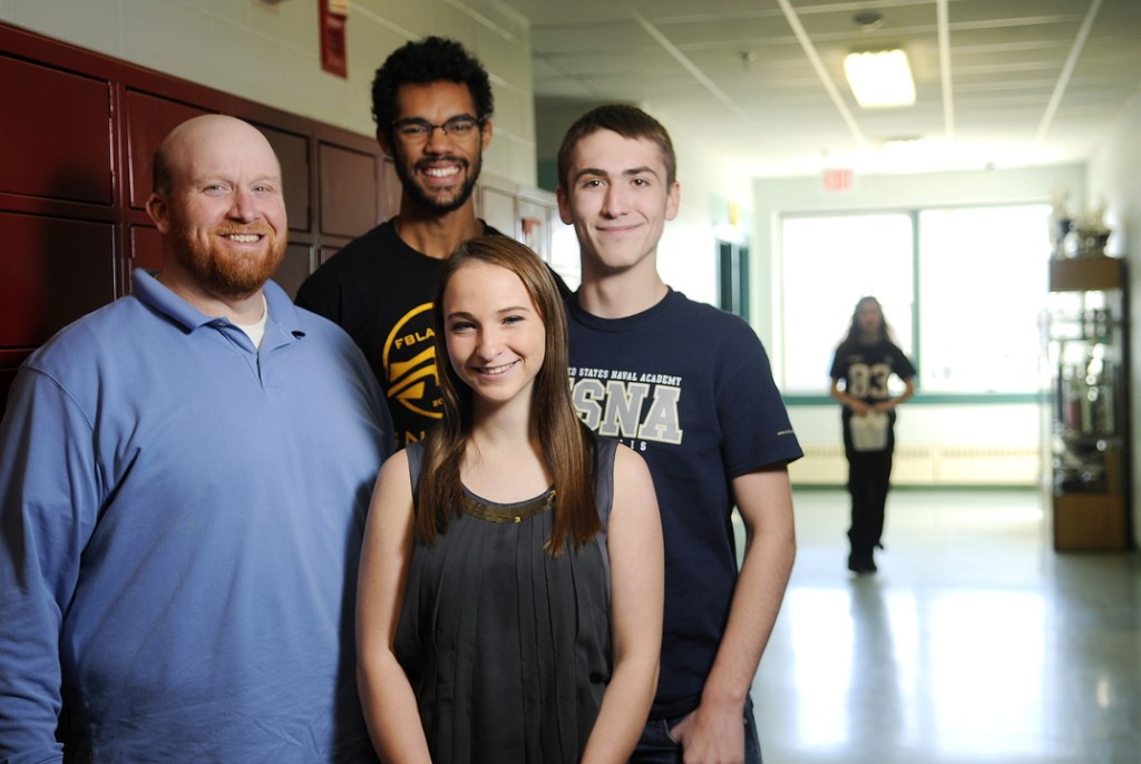 Monmouth Academy teacher Scott Wing, left, and National Honor Society students Angus Kollen, right, Ashley Coulombe and Marcques Houston plan to start a food bank run by students at the school.