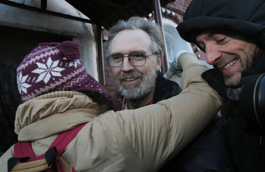 Greenpeace International activist Colin Russell of Australia, center, is greeted as he leaves a jail after being freed on bail in St.Petersburg, Russia, on Friday. Russell is the last one of the 30 people to be granted bail of those on board the Arctic Sunrise ship who were arrested during a Greenpeace protest in Arctic waters. The charges against the accused protesters still stand.