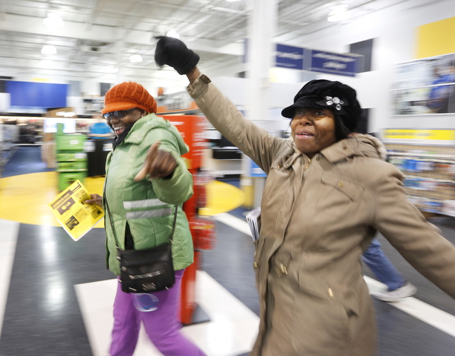 Black Friday shoppers Paulette Darby of South Portland, left, and Annmarie Warburton of Portland, hit the floor running after being among the first to enter Best Buy in South Portland at midnight on Friday.