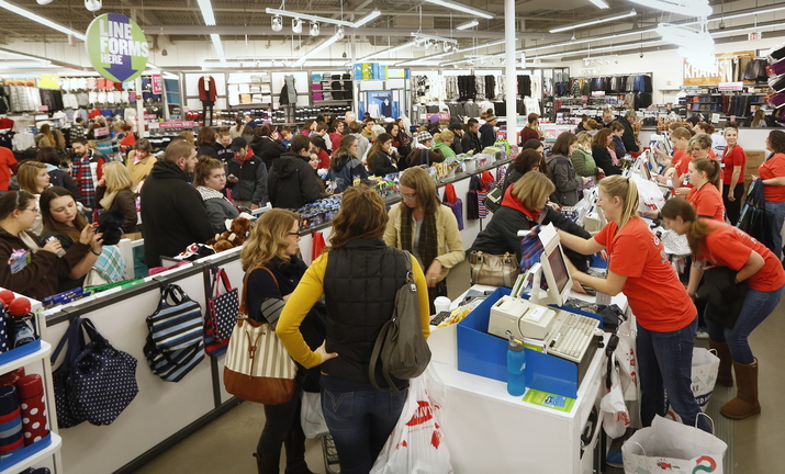 Sales associates work the registers as a long line forms with Black Friday shoppers at Old Navy in South Portland shortly after midnight.