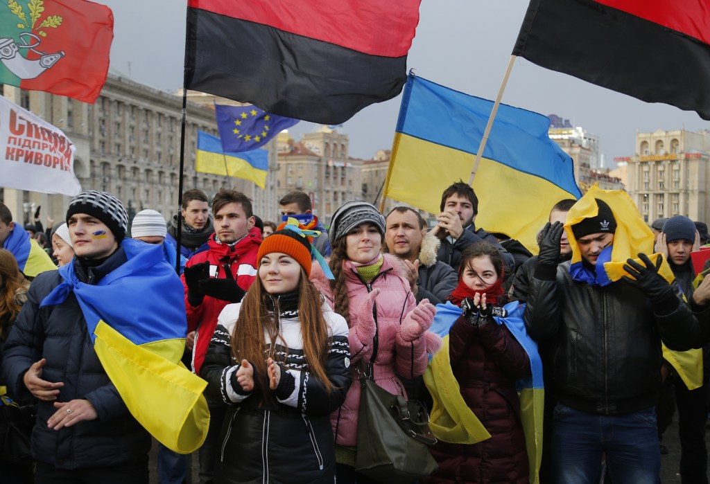 Demonstrators protest during a rally in support of Ukraine's integration with the European Union in the center of Kiev, Ukraine, Friday Nov. 29, 2013. The European Union extended its geopolitical reach eastward on Friday by sealing association agreements with Georgia and Moldova, but blamed Russia for missing out on a landmark deal with Ukraine. (AP Photo/Sergei Grits)