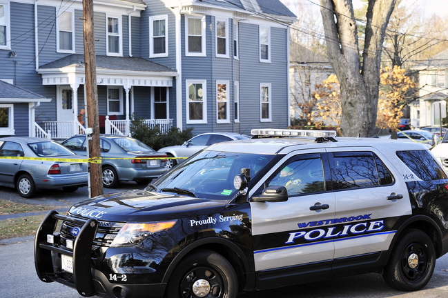 A Westbrook police officer parks his sport utility vehicle to block traffic on Waltham Street in Westbrook as state police investigated an apparent domestic-violence slaying and suicide Saturday. The violence left two men dead.