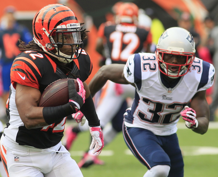 Cincinnati’s BenJarvus Green-Ellis is hotly pursued by New England free safety Devin McCourty, a former first-rate cornerback thriving in his new position in the Patriots’ defensive backfield.