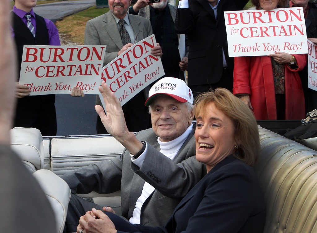 Riding with New Hampshire’s Gov. Maggie Hassan, Executive Councilor Ray Burton waves to supporters Friday in Bretton Woods, N.H., as he arrives for a an opening ceremony at a scenic overlook dedicated to him. Burton is a staunch advocate for northern Vermont.