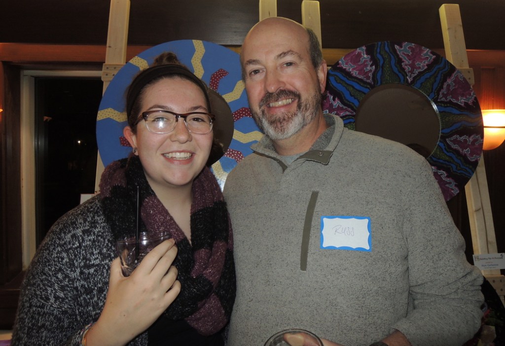 Eda French, a 16-year-old Casco Bay High School student who contributed the “Cat’s Meow” mirror to be sold at the auction, with her father, Russell French, of Portland at the Painting for a Purpose fundraiser at DiMillo’s.