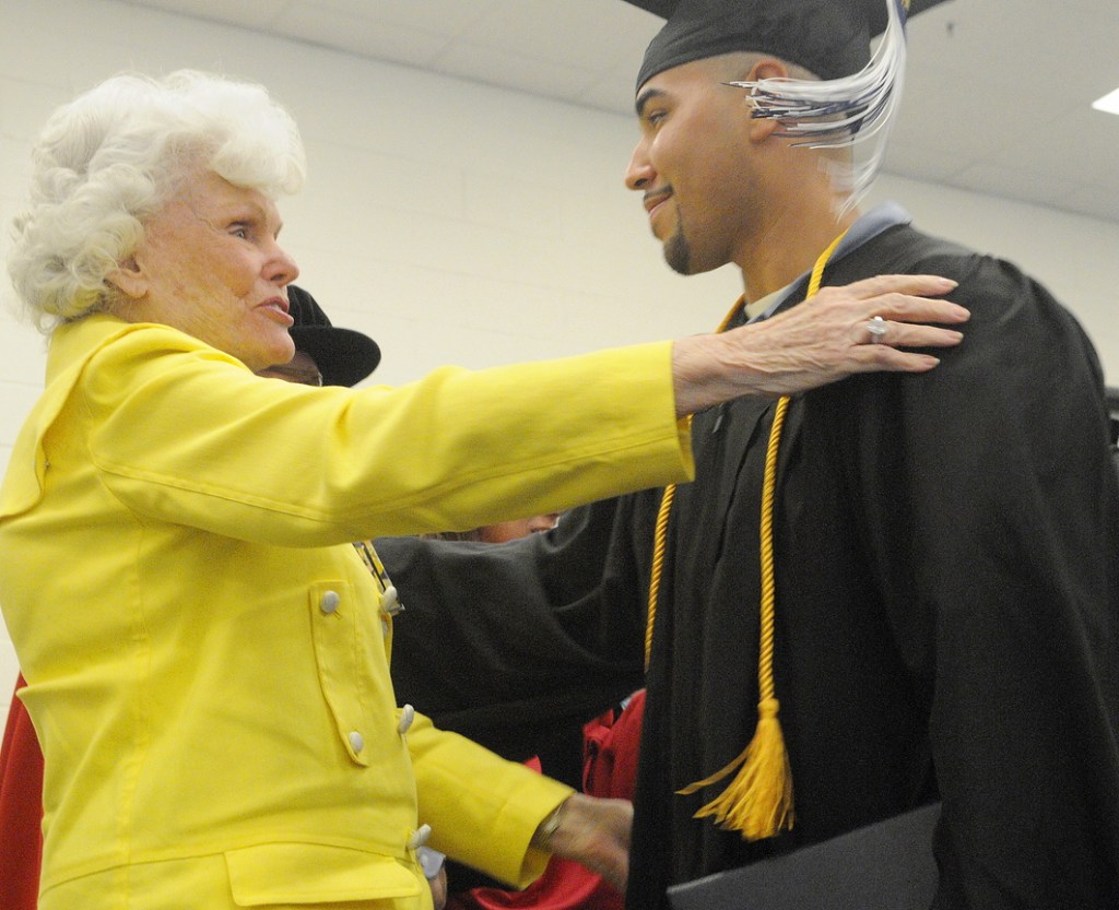 Maine State Prison inmate Sergio Hairston hugs philanthropist Doris Buffett on Monday after he received his diploma from the University of Maine at Augusta.