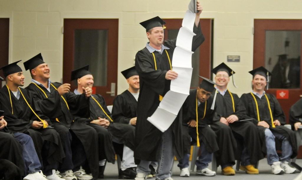 Maine State Prison inmate Steven Clark holds up a speech about everyone he wanted to thank Monday after he and 13 other men incarcerated at the Warren prison received their diplomas from the University of Maine at Augusta.
