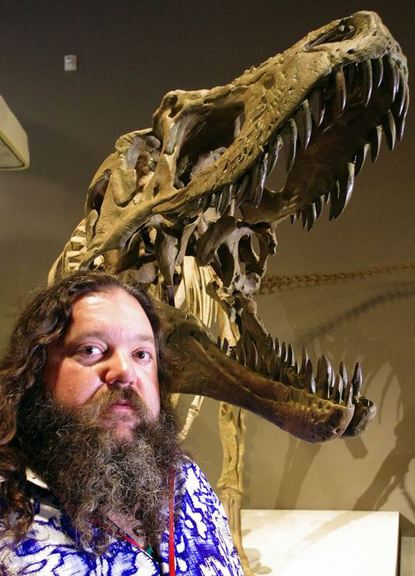 Paleontologist Mark Loewen is shown with the skeleton on display in Salt Lake City.
