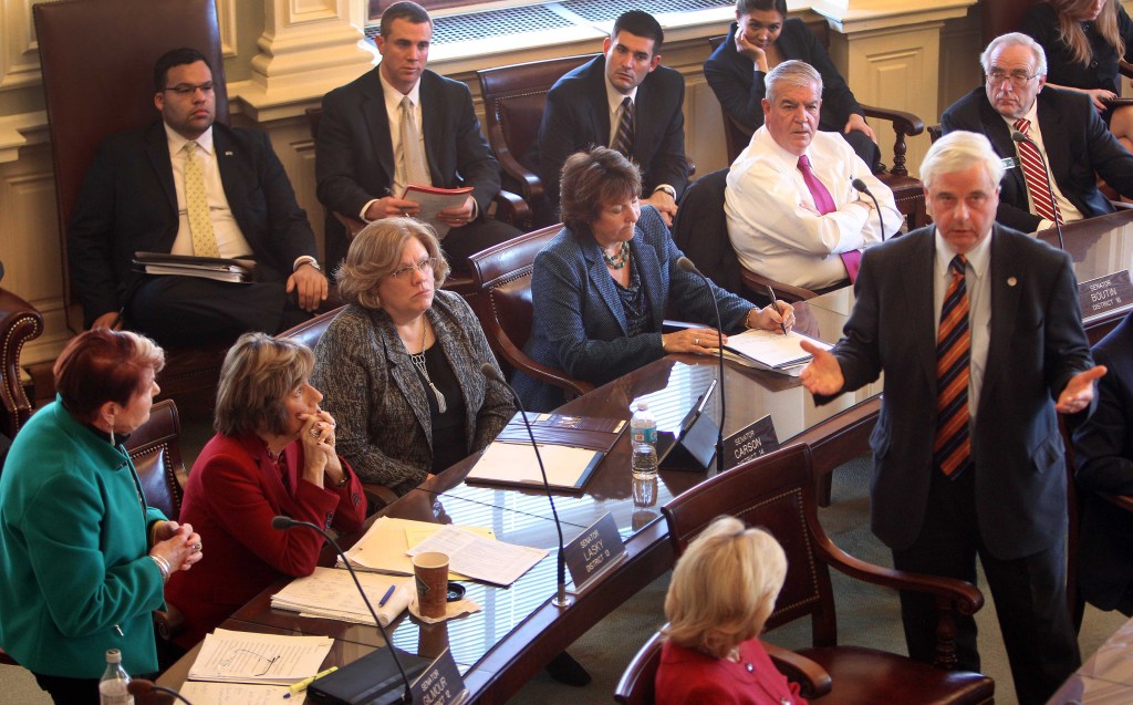 State Sen. Peggy Gilmour, D-Hollis, left, listens as Sen. Jeb. Bradley, R-Wolfeboro, answers her question during a special session the N.H. Legislature on Thursday at the Statehouse in Concord, N.H.