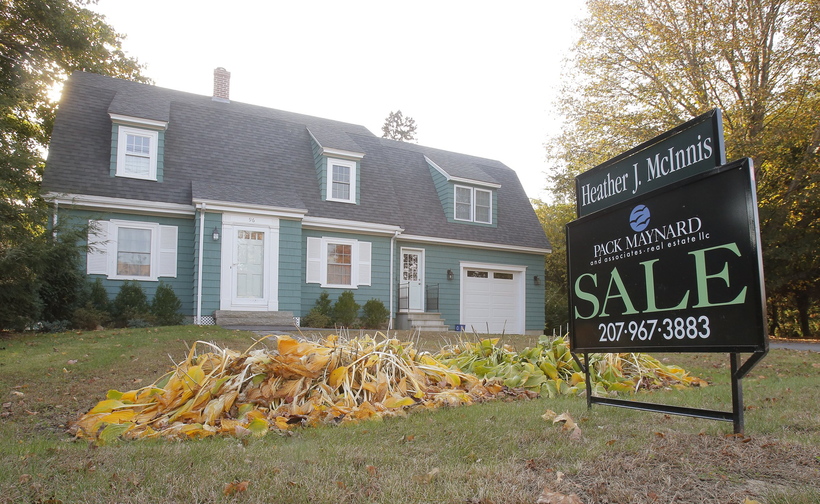 A for sale sign is posted in front of a home in Kennebunk in September. The number of Maine home sales continued its September increases into October.