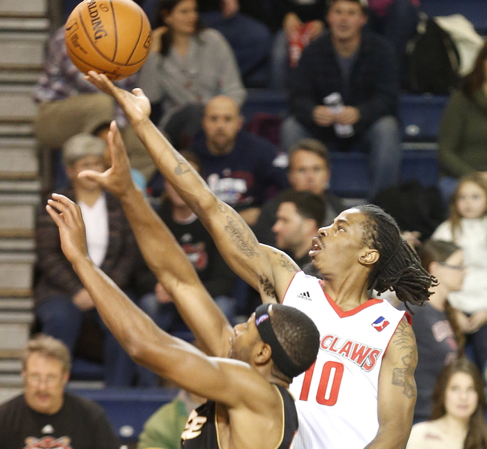 Maine’s Marcel Anderson scores above Mustafa Shakur of Erie during the second quarter of the Red Claws’ 127-100 win Sunday at the Expo.