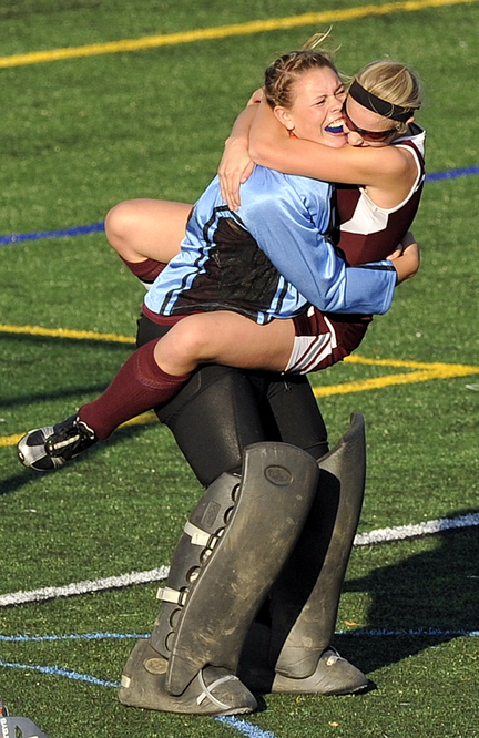 Gabe Souza/Staff Photographer Foxcroft goalie Brianna Skolfield hugs teammate Amber Anderson after the Ponies defeated NYA for the Class C field hockey championship at Yarmouth High School Saturday, November 2, 2013.