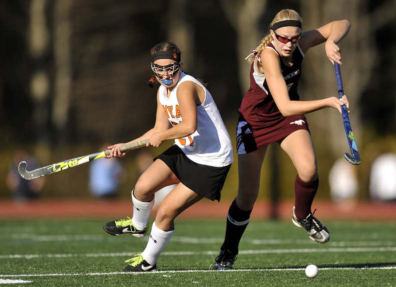 Gabe Souza/Staff Photographer NYA's Juliana Tardiff looks back toward the ball as Foxcroft's Amber Anderson makes a charge at it during the first half of the Class C field hockey championship at Yarmouth High School Saturday, November 2, 2013.